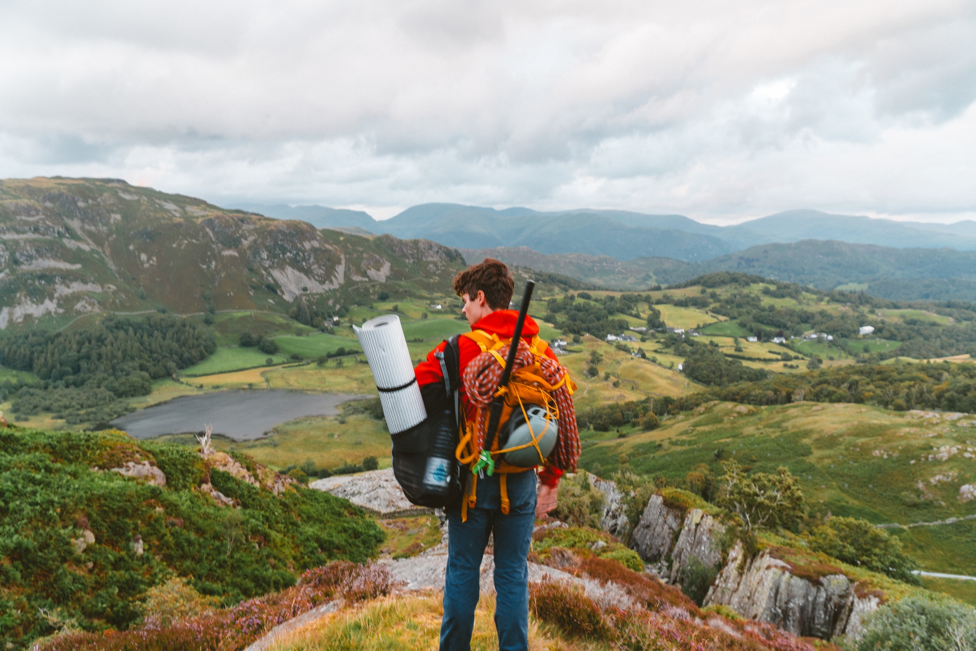 A hiker pauses atop a scenic overlook, taking in the breathtaking vista.