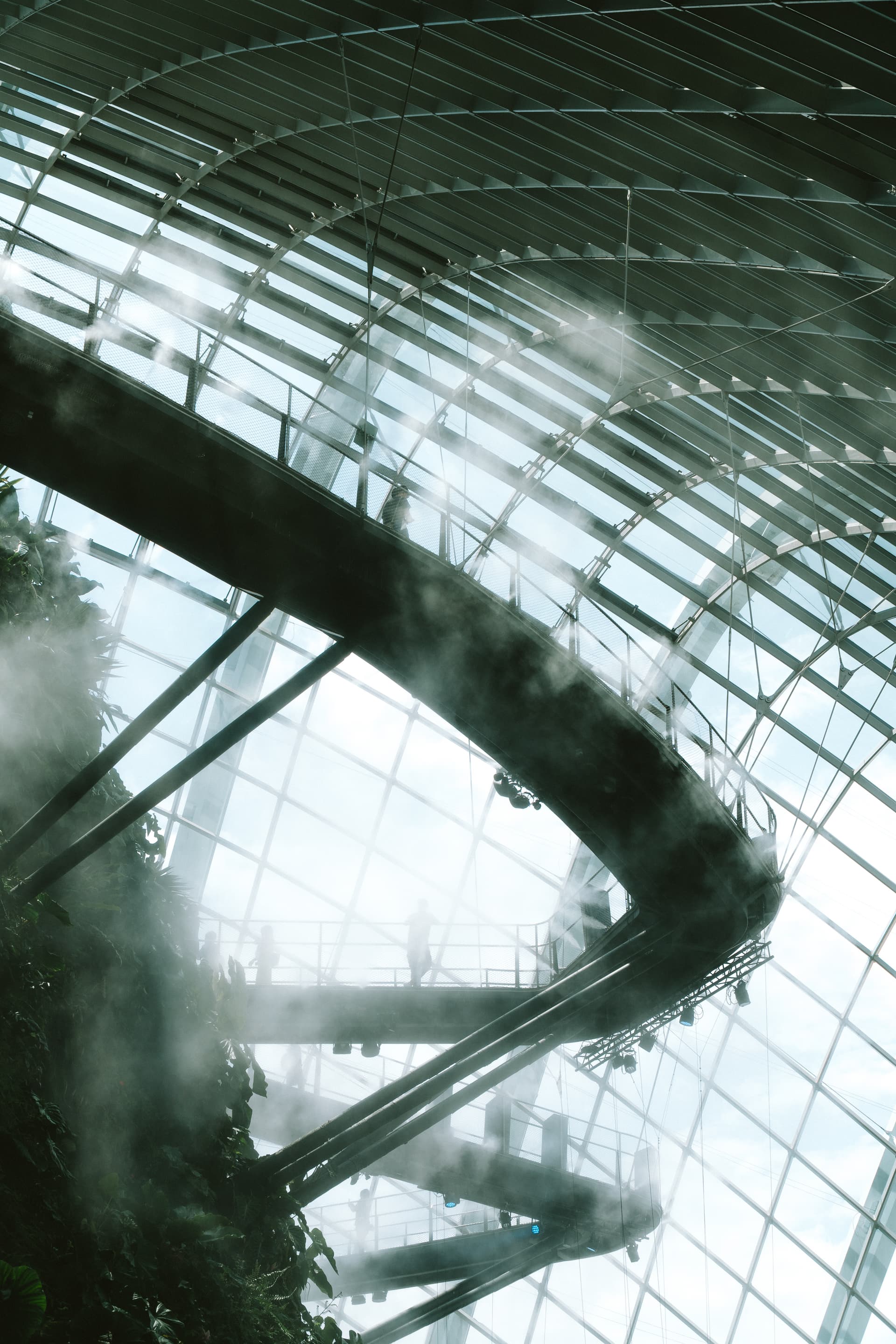 A modern architectural marvel with geometric patterns, light, and mist, creating a surreal atmosphere.
